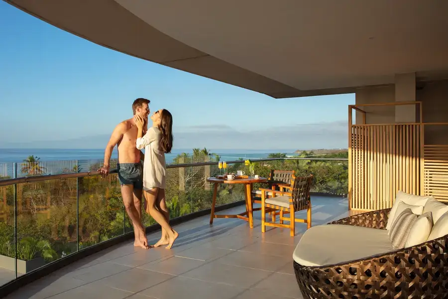 Couple on room terrace at sunset