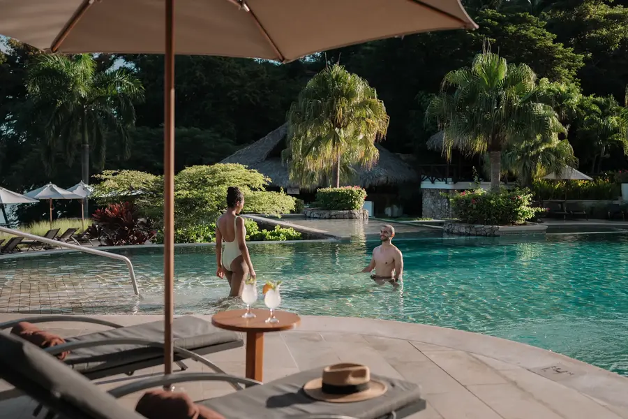 Couple having drinks at the pool