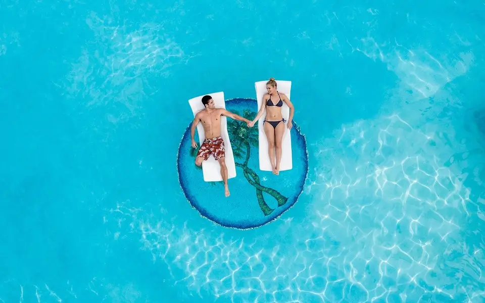 Couple lounging in main pool