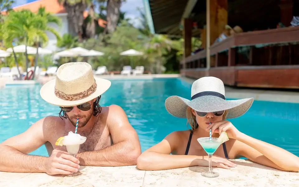 Couple enjoying drinks at the pool