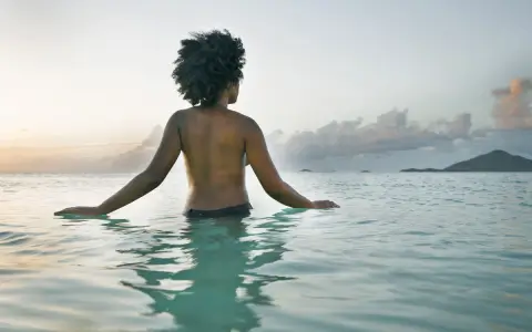 topless woman in the ocean at Grand Lido