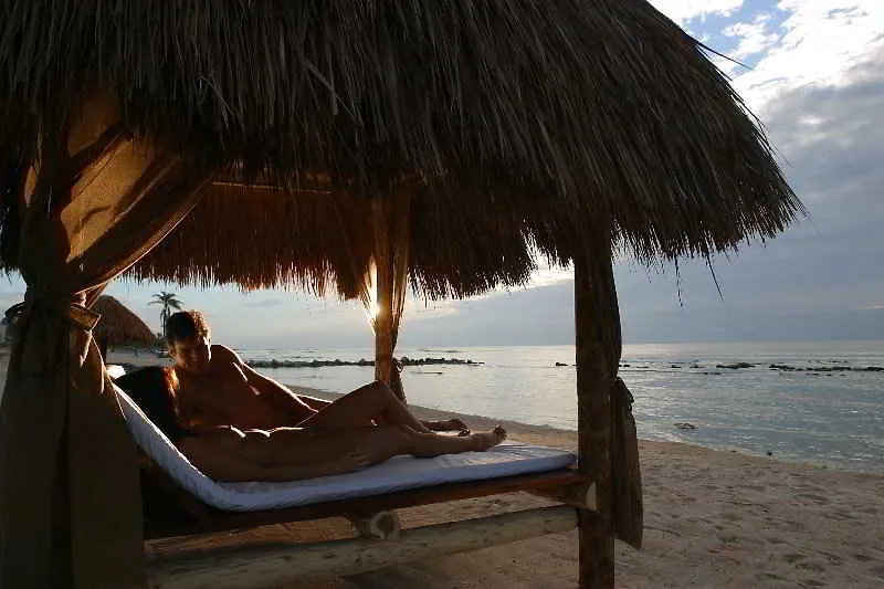 Nude couple enjoying a palapas