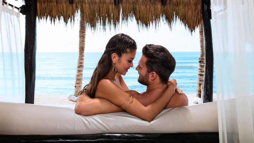 Couple enjoying a bed on the beach